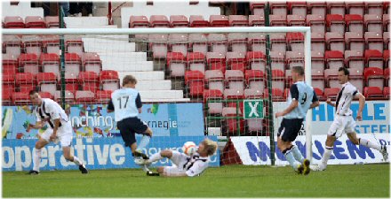 Neil McGregor slides in to prevent a goal