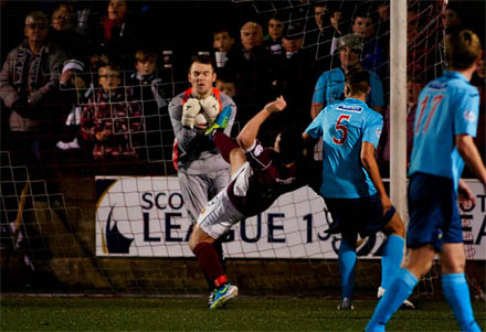 Ryan Scully saves at the boot of Sean Higgins