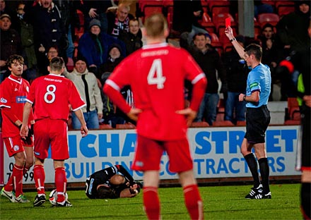 Des Roache shows Stuart Anderson a red card