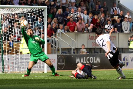 Steven McDougalls shot is saved by Falkirk keeper Bobby Olejnik