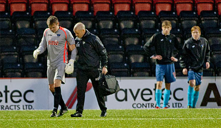 Ryan Scully is assisted off by physio Kenny Murray